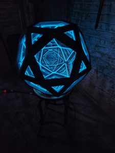 Illuminated geometric LED art sculpture with blue neon lights, perfect for modern home decor.