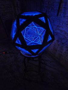 Illuminated geometric LED art piece with blue glow, handcrafted by Chris Knight Creations.