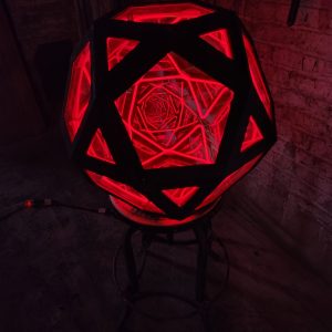 Vibrant red LED geometric art sculpture by Chris Knight Creations, illuminated for modern decor.