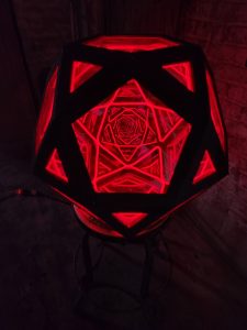 Illuminated geometric LED lamp with intricate red patterns, stylish home decor by Chris Knight Creations.