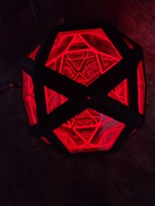 Vivid LED geometric art sculpture with red lighting, modern and abstract decorative piece.