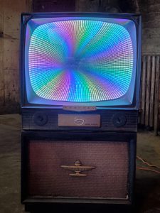 Colorful vintage arcade game with vibrant rainbow LED display.