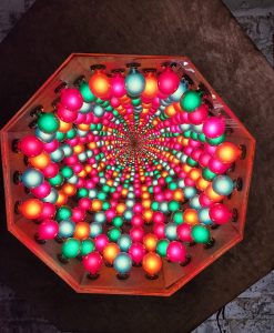 Colorful illuminated LED art installation featuring vibrant pink, green, orange, and blue lights.