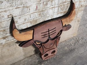 Handcrafted wooden bull head wall decor with rustic finish, perfect for country-style homes.