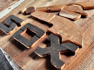 Handcrafted wooden signs and letters from Chris Knight Creations, showcasing rustic and custom woodwork art.
