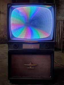 Colorful vintage CRT TV with rainbow LED display, part of Chris Knight Creations' unique art installations.