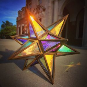 Colorful stained glass star lantern for outdoor decor and festive lighting.