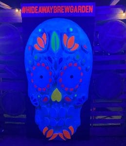 Vibrant LED Sugar Skull display at Hideaway Brew Garden for festive decoration and photo opportunities.
