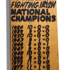 Handcrafted wooden sign celebrating Notre Dame Fighting Irish football championship wins.