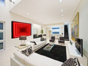 Vibrant modern living room with bold neon art and sleek furniture, showcasing Chris Knight Creations interior design.